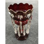 A Victorian ruby red glass lustre with drops