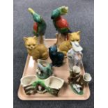A tray containing pottery cat ornaments, Fowler ware vases, a pair of German parakeet figures,