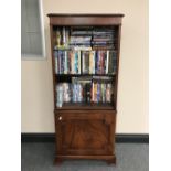 A set of inlaid mahogany Bradley bookshelves containing a large quantity of DVD's and boxsets
