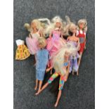 A box containing six twentieth century Barbie dolls with clothes
