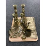 A tray containing two relief panels, brass measures, brass trivet,