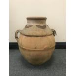 A large terracotta twin handled urn with metal mounts