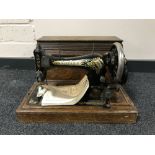 A mid twentieth century oak cased Singer hand sewing machine