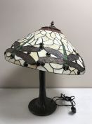 A Tiffany style table lamp with leaded glass shades of dragonfly design