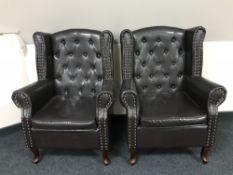 A pair of leather-look button back armchairs