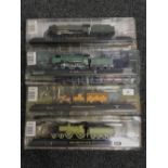 Four model trains on stands including Stephenson's Rocket