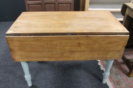 An antique pine flap sided table with painted legs