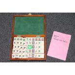 A mahjong set in carved wooden box