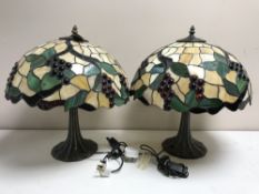 A pair of Tiffany style table lamps with leaded glass shades of grape design