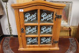 A pine glazed door wall cabinet - Pears Soap CONDITION REPORT: This measures 59cm