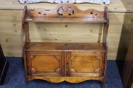 An antique mahogany wall cabinet with fitted shelf above