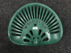 A cast metal W M Doyle & Company Ltd tractor seat