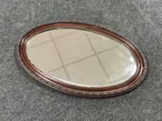 An early twentieth century oval framed bevel edged mirror