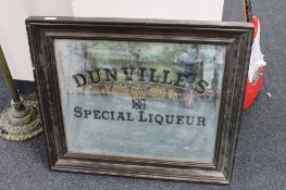 An early twentieth century oak framed mirror bearing later Dunville's Special Liqueur advertising