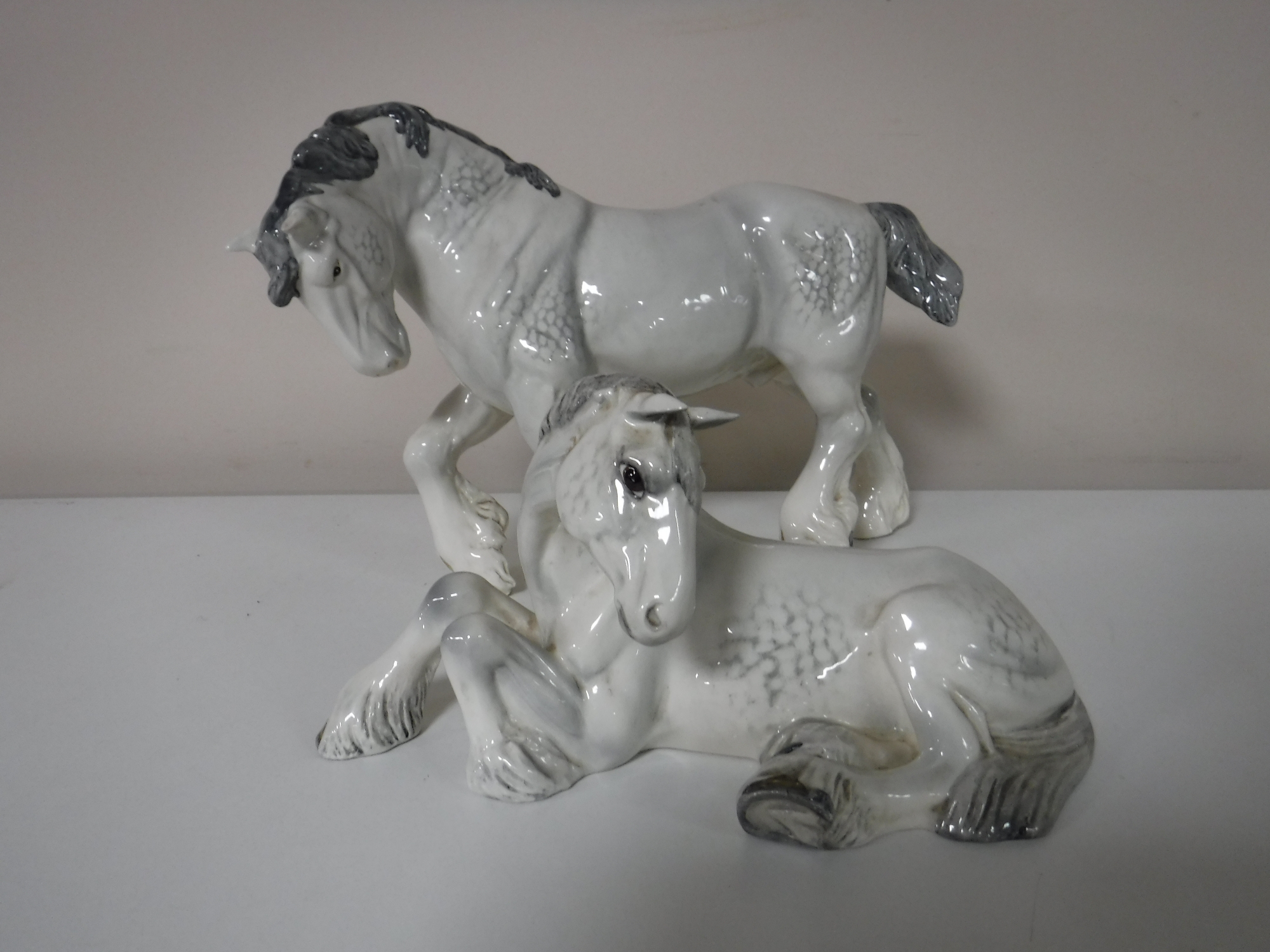 A Beswick figure of a shire horse, front foot raised, grey, (a/f),