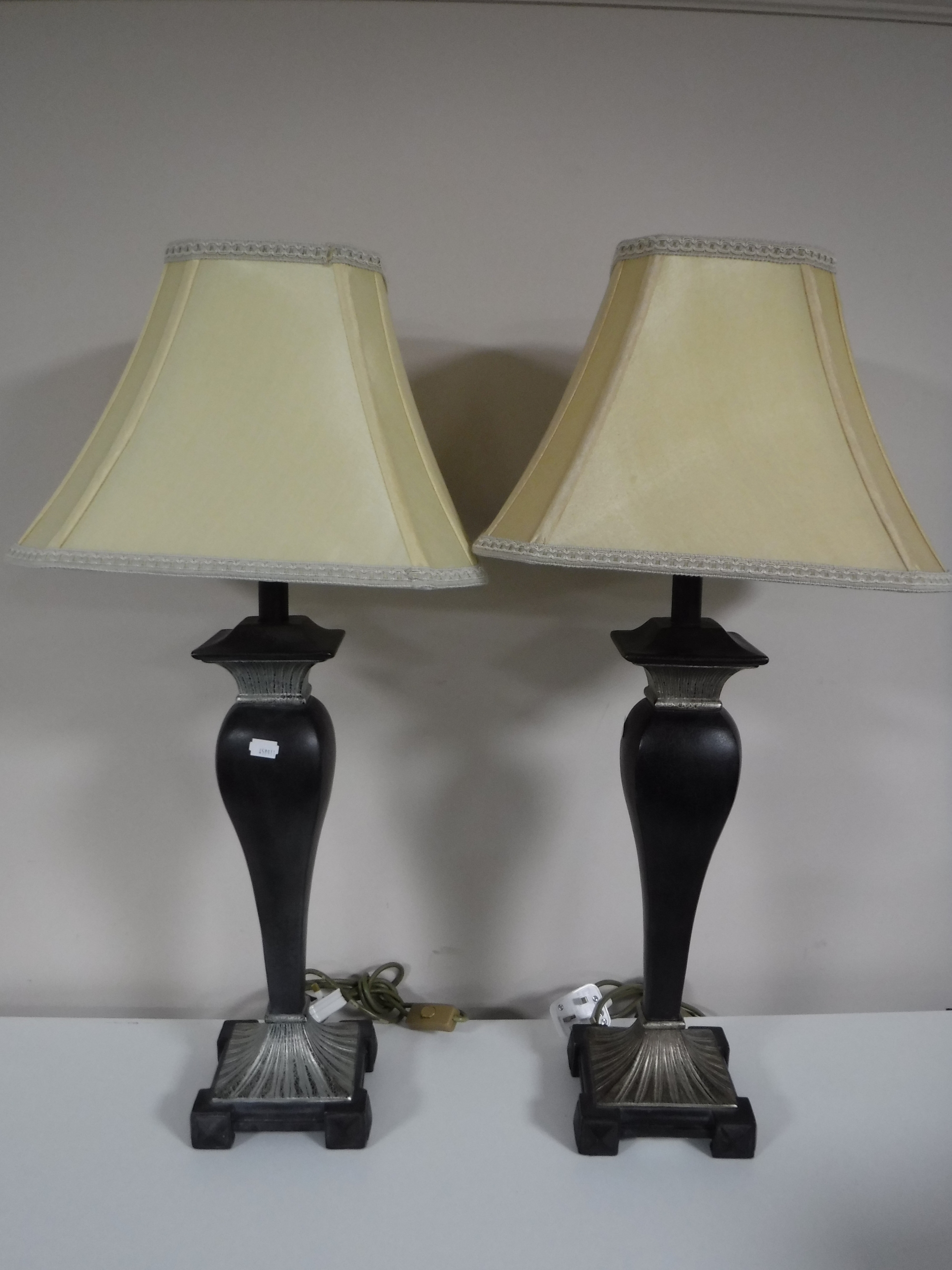 A pair of contemporary table lamps with shades