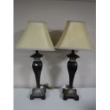 A pair of contemporary table lamps with shades