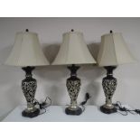 A set of three contemporary table lamps with shades