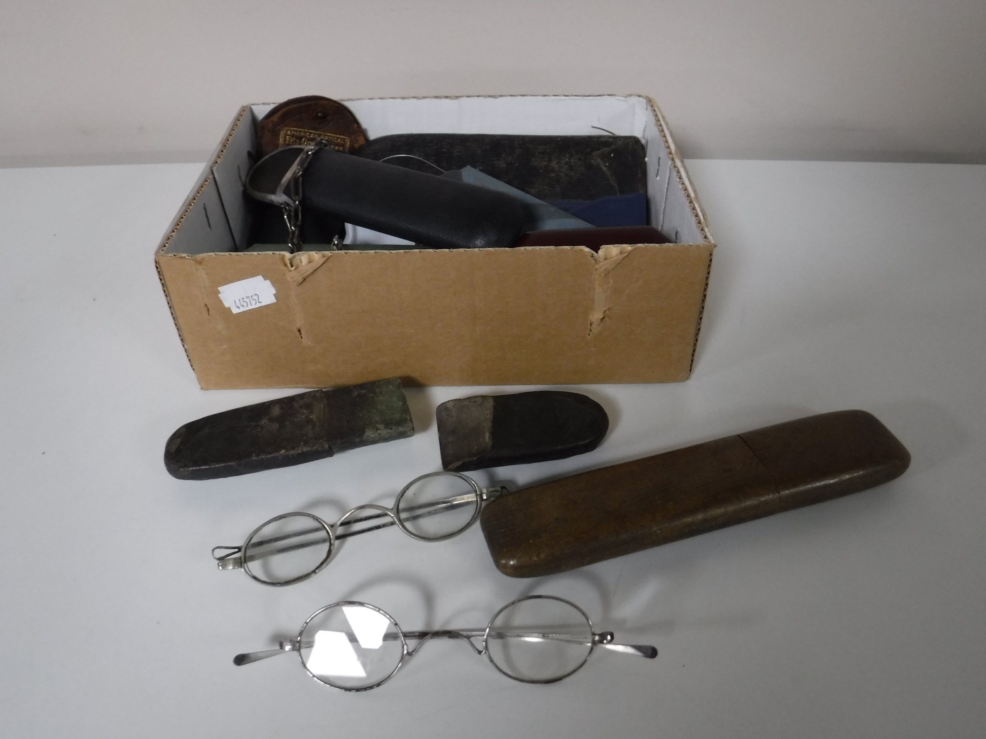 A box containing vintage spectacles and spectacle cases