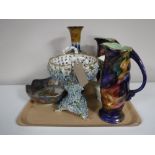 A tray containing a pair of Maling Storm jugs, together with a Ringtons Maling lustre jug,