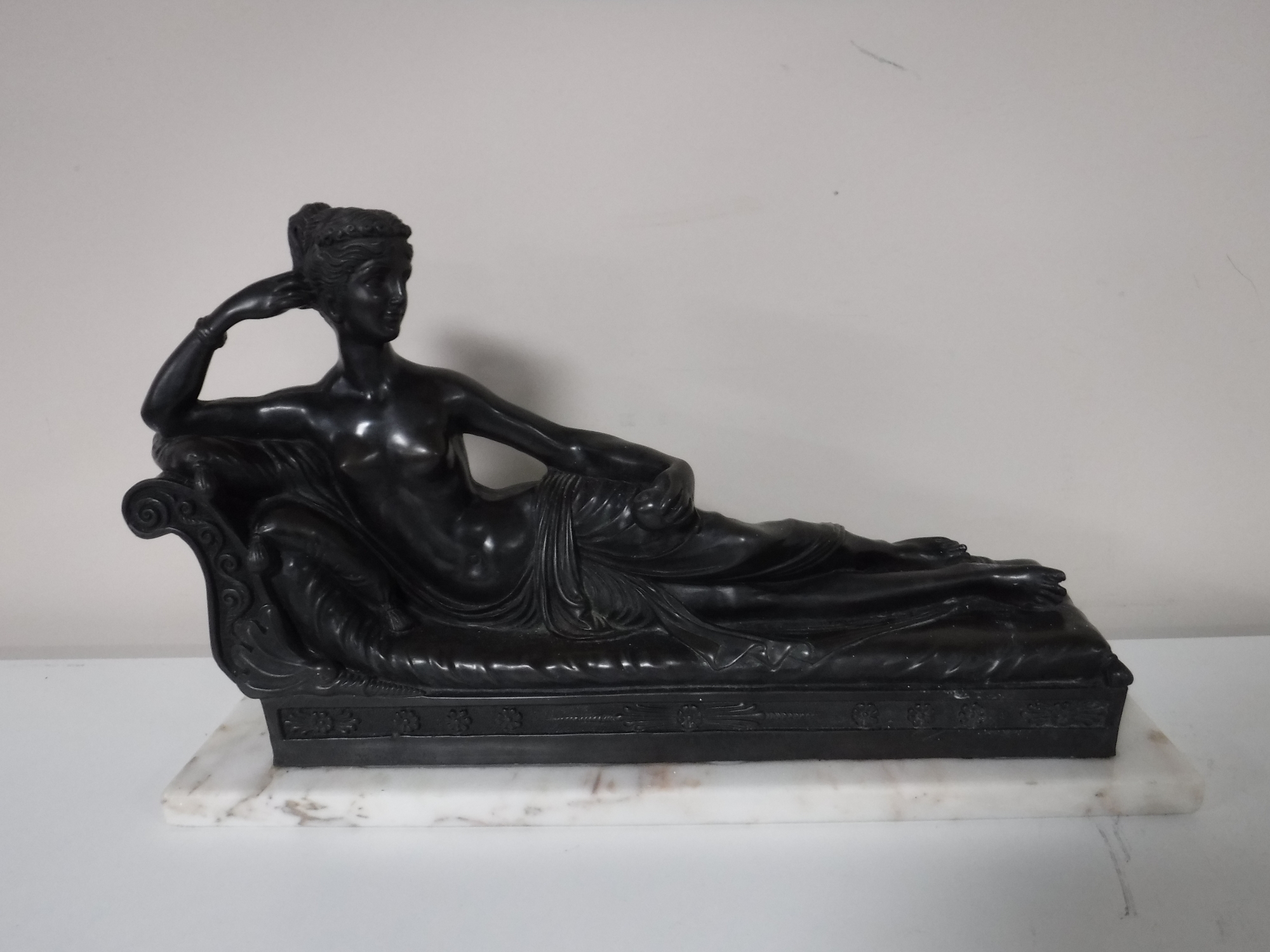 A resin classical style figure on a marble base