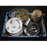 A box containing assorted dinner plates and wall plates,