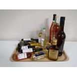 A tray of various alcohols including Napoleon Brandy, Harvey's Sherry, Merlot,