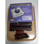 A Hornby 00 Gauge Hogwarts Express with two carriages and a Bachmann train control system
