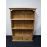 A set of pine wall shelves fitted two drawers