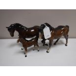 Two Beswick horses (front foot raised,