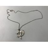 A sterling silver Chinese dragon pendant on silver chain