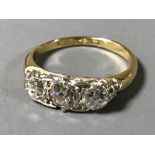 A Victorian diamond ring, set with three round old cut diamonds, the largest approximately 4.