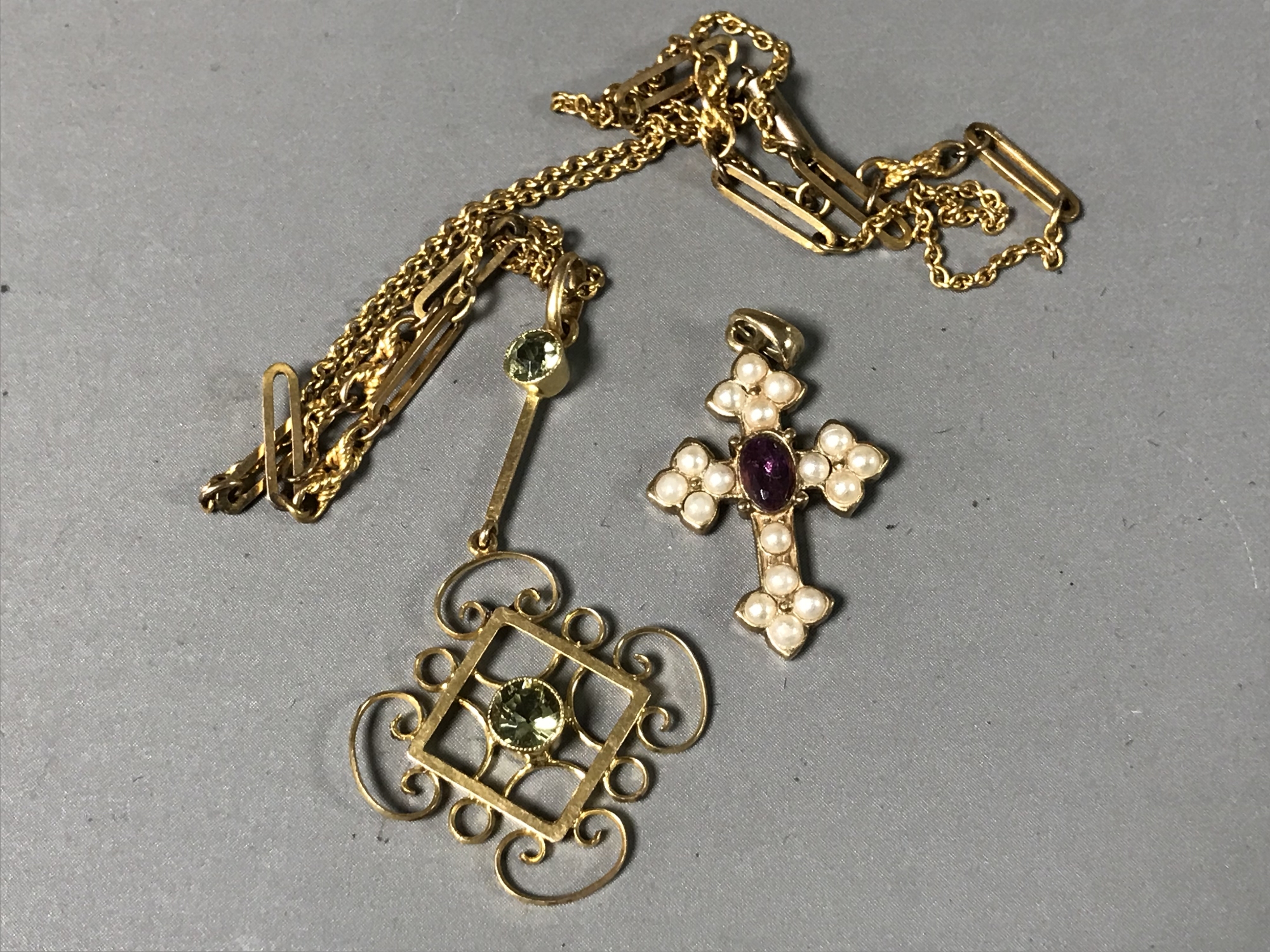 A 9ct gold Edwardian peridot pendant and chain together with a pearl and amethyst cross pendant.