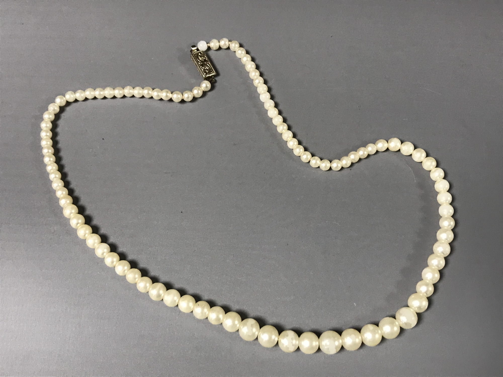 A cultured pearl necklace with sterling silver clasp