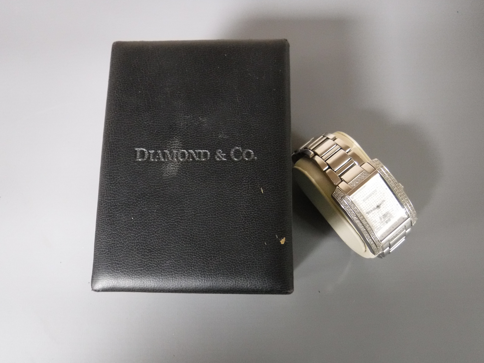 A Gents diamond set stainless-steel wristwatch, signed Diamond & Co, quartz movement,