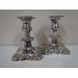 A pair of silver plate on copper candlesticks with detachable sconces,