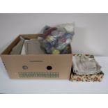 Two boxes containing vintage linen and clothing,