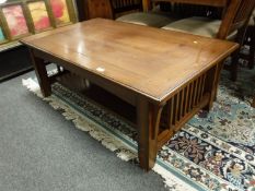 A contemporary arts and crafts style oak low table with undershelf,