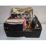A box containing LP's, 45's and CD's, including The Beatles, Stevie Wonder, Madonna,