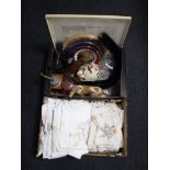 Two boxes containing table linen, wall plates, coffee grinder, figurines, glassware,