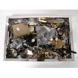 A mirrored tray containing a large quantity of assorted wrist watches, costume jewellery, purse,