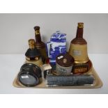 A tray containing Bells scotch whiskey decanters, a cased Royal Navy ships compass,