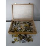 A box containing a quantity of military badges