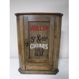 A small antique hanging oak corner cupboard bearing Wills Cigarette advertisement