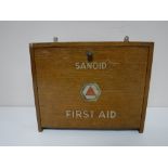 A mid 20th century oak Sanoid first aid box