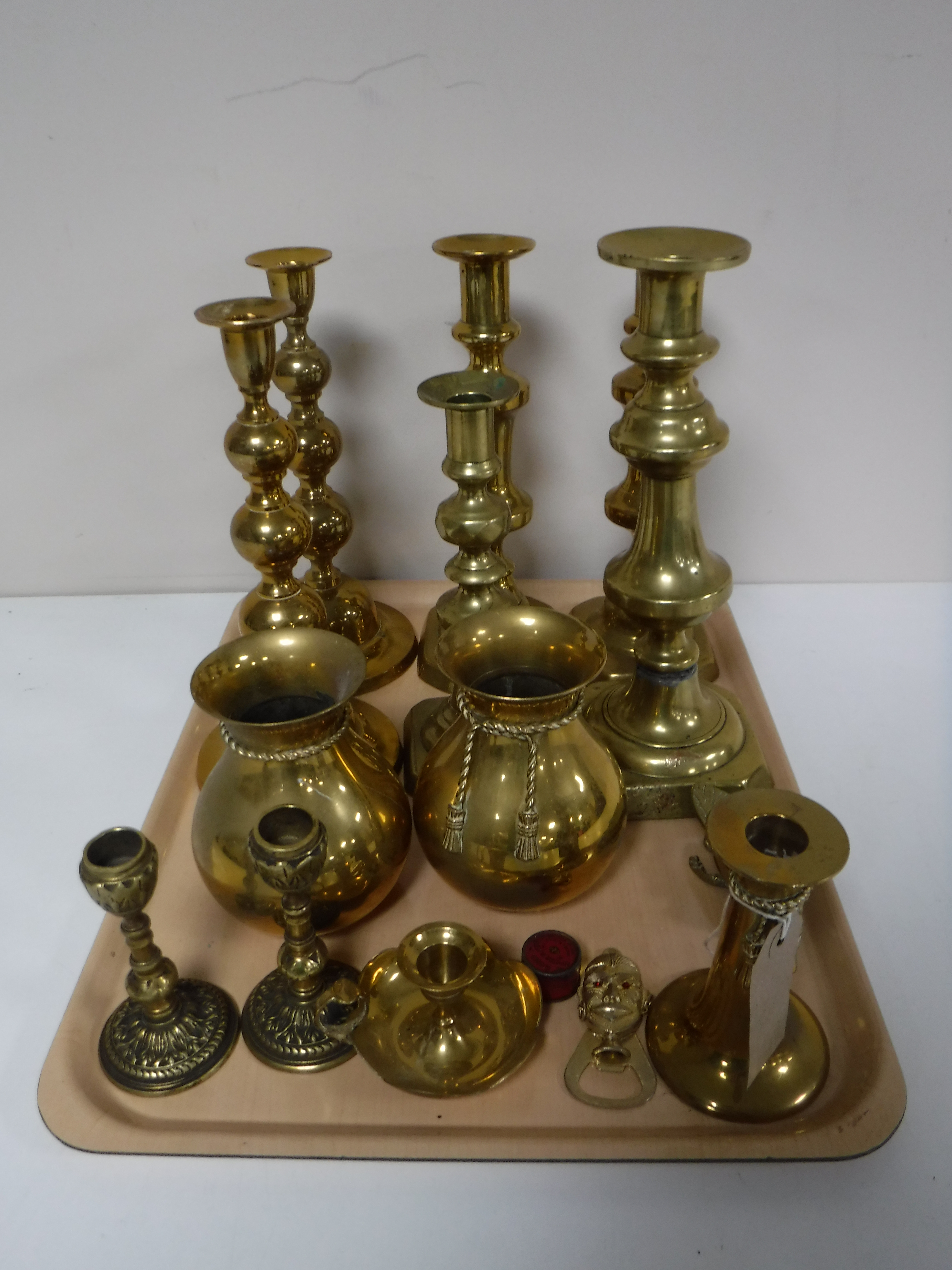 A tray containing a large quantity of brass ware including candlesticks, pair of vases,