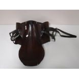 A leather saddle with stirrups