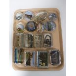 A tray of sixteen early/mid 20th century glass tourist paperweights