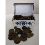 A tin containing Georgian pennies and half pennies, three pence pieces,