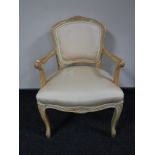 A beech framed armchair in peach upholstery